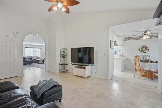 living room featuring high vaulted ceiling and ceiling fan