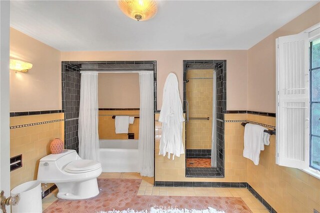 bathroom featuring tiled shower, tile patterned flooring, tile walls, and toilet