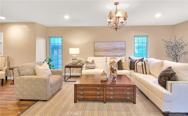 living room with a chandelier and light hardwood / wood-style floors