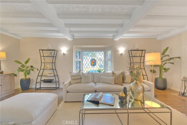 living room featuring beamed ceiling, coffered ceiling, and light hardwood / wood-style flooring