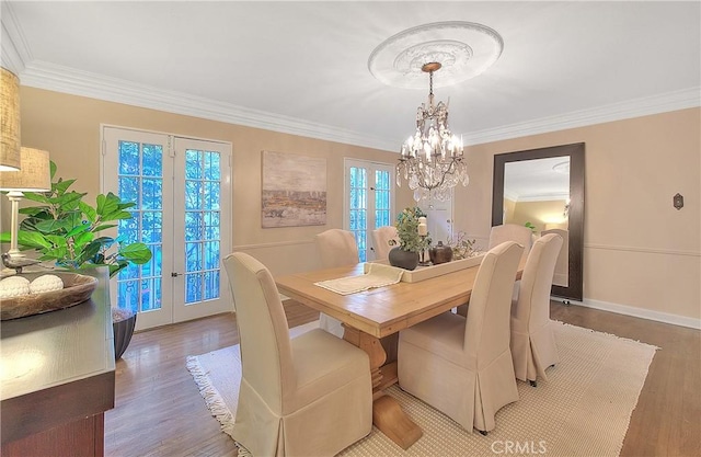 dining area featuring french doors, plenty of natural light, and hardwood / wood-style flooring