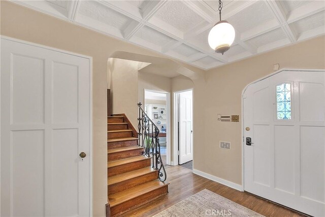 foyer with beamed ceiling, wood-type flooring, and coffered ceiling