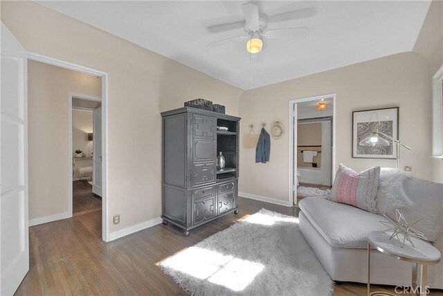 sitting room with ceiling fan and dark hardwood / wood-style flooring