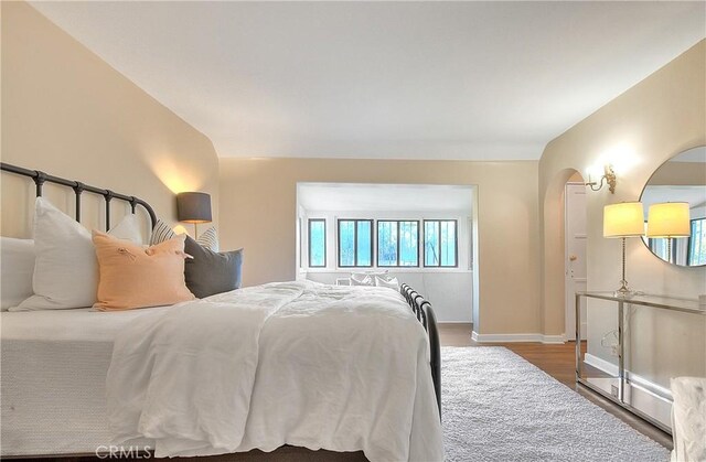 bedroom with hardwood / wood-style flooring