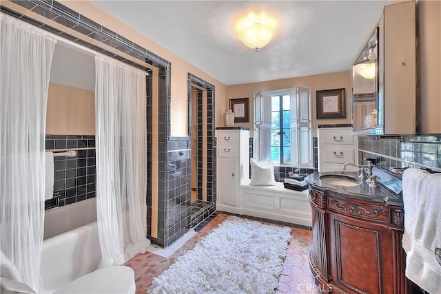 bathroom with vanity and tile walls