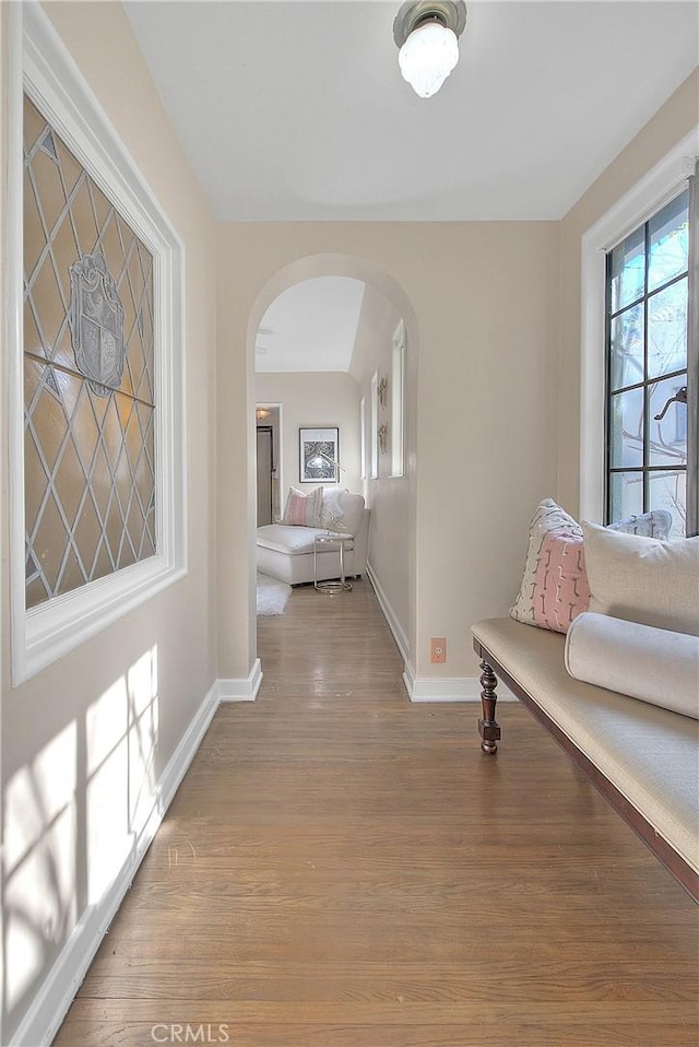 corridor with hardwood / wood-style flooring