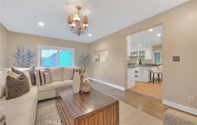 living room featuring light hardwood / wood-style floors and a chandelier