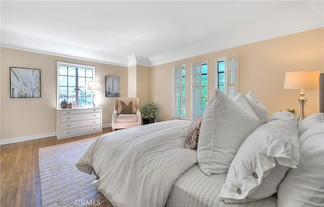 bedroom with wood-type flooring and ornamental molding