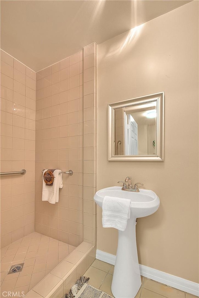 bathroom with tile patterned floors and tiled shower