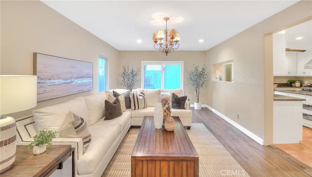 living room featuring a notable chandelier and light hardwood / wood-style floors