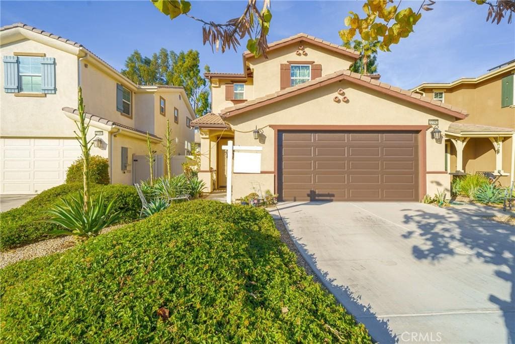 mediterranean / spanish-style home with a garage