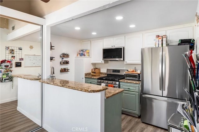 kitchen featuring green cabinets, stone countertops, white cabinetry, wood-type flooring, and stainless steel appliances