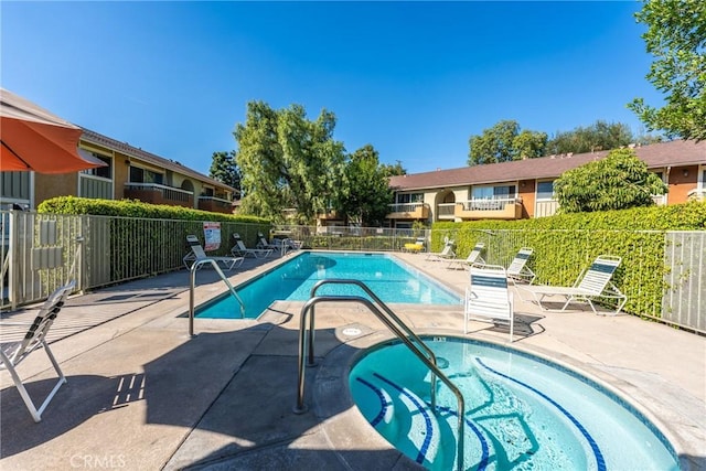 view of pool with a community hot tub and a patio