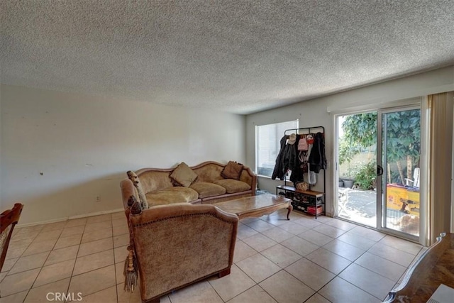 living room with a textured ceiling and light tile patterned floors