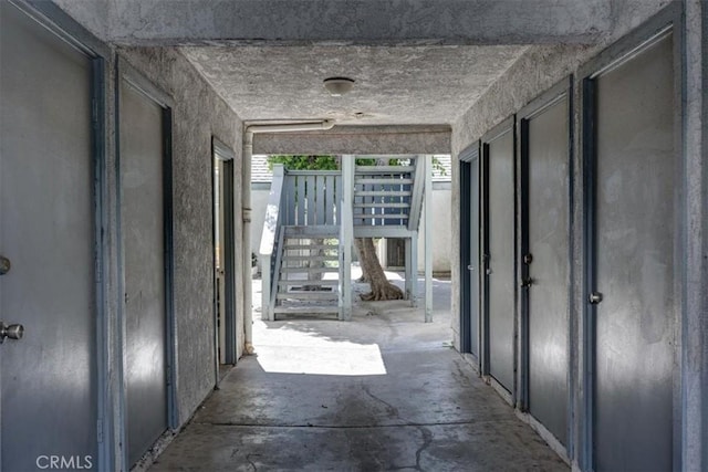 hall featuring unfinished concrete floors