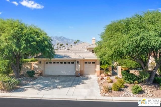 view of front facade featuring a mountain view and a garage