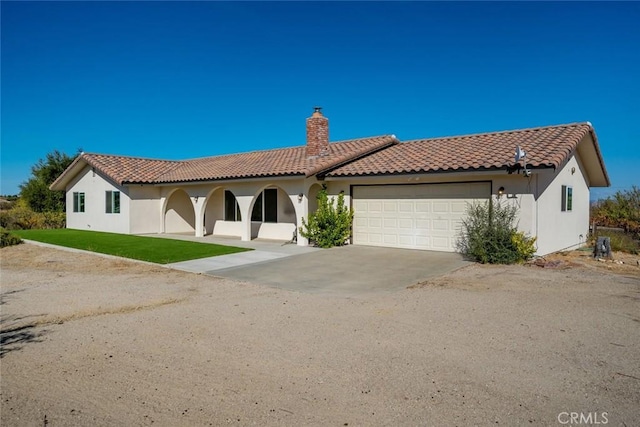 mediterranean / spanish home featuring a garage