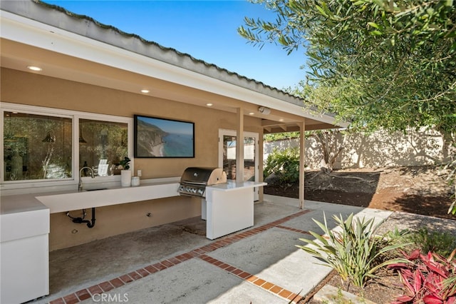 view of patio featuring a grill and an outdoor kitchen