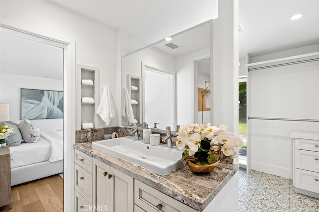 bathroom with hardwood / wood-style flooring and vanity