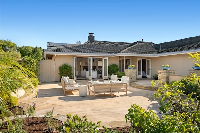 rear view of house with an outdoor hangout area and a patio