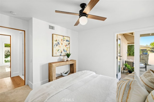 bedroom with light wood-type flooring, multiple windows, and ceiling fan