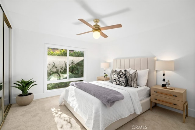 bedroom featuring ceiling fan, a closet, and light carpet