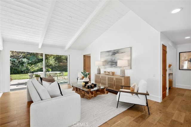 living room with light wood-type flooring and lofted ceiling with beams