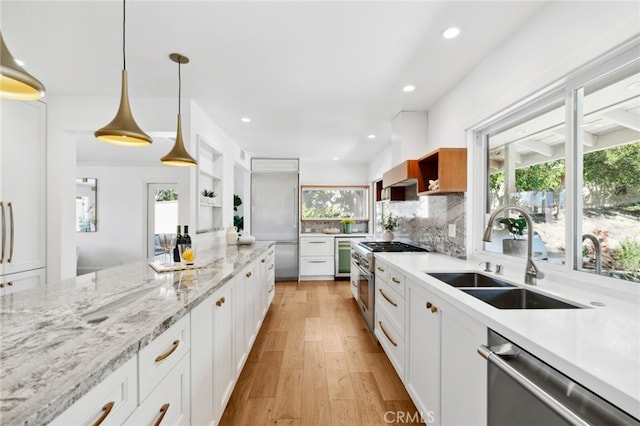 kitchen featuring white cabinets, pendant lighting, light hardwood / wood-style floors, and high end appliances