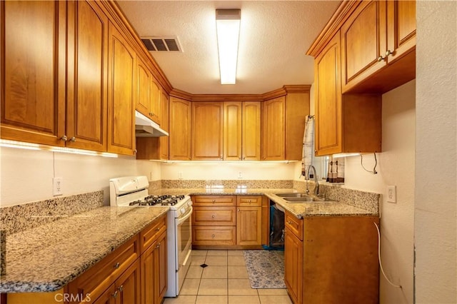 kitchen featuring sink, white gas range, a textured ceiling, light tile patterned floors, and light stone counters