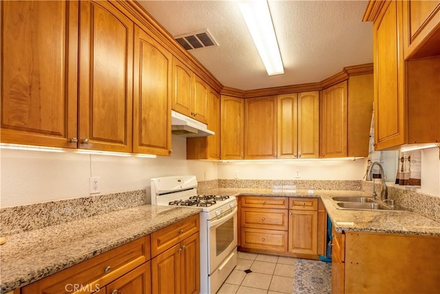 kitchen with light stone countertops, a textured ceiling, sink, light tile patterned floors, and white range with gas stovetop