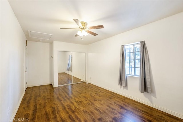 unfurnished bedroom featuring a closet, ceiling fan, and dark wood-type flooring