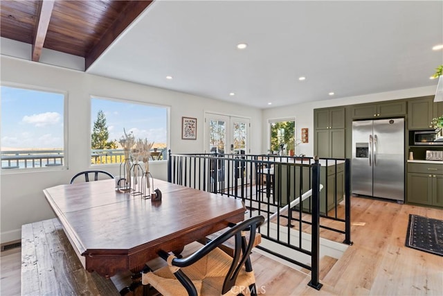 dining area featuring beam ceiling, french doors, wooden ceiling, and light wood-type flooring