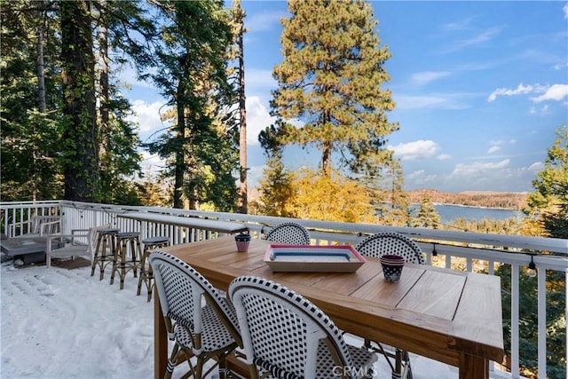 wooden terrace featuring a water view