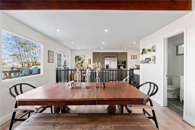 dining space featuring french doors and light wood-type flooring