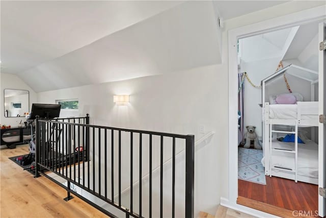 corridor featuring vaulted ceiling and hardwood / wood-style flooring