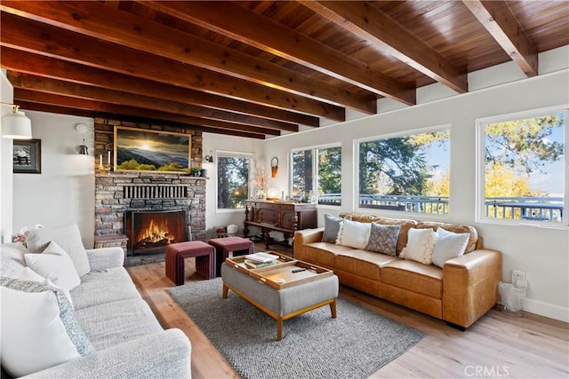 sunroom / solarium featuring beam ceiling, wood ceiling, and a fireplace