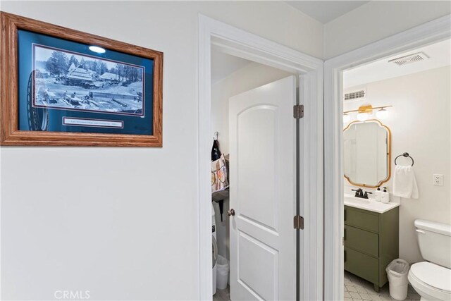 bathroom featuring vanity and toilet