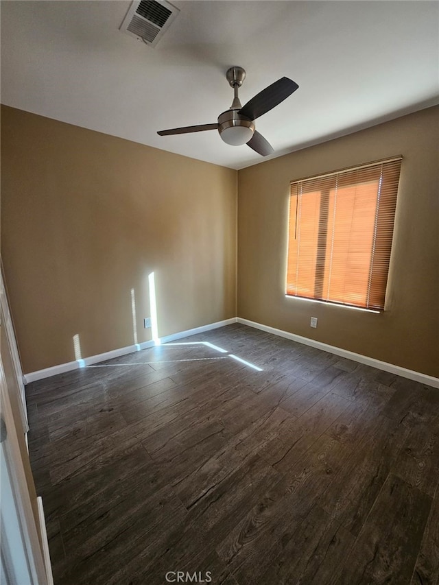 empty room featuring ceiling fan and dark wood-type flooring