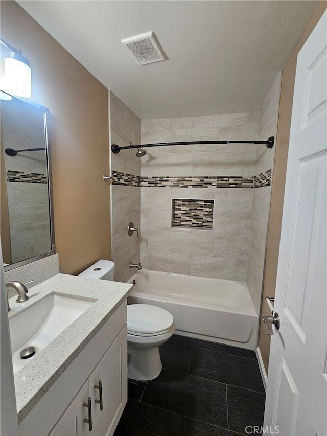 full bathroom with tile patterned flooring, vanity, toilet, and tiled shower / bath