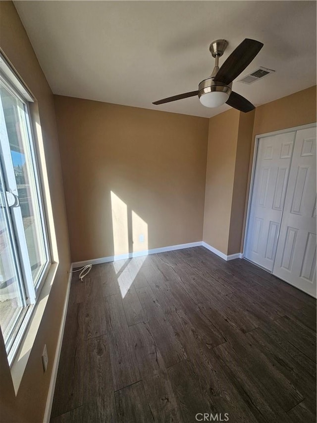 unfurnished room featuring dark hardwood / wood-style floors and ceiling fan