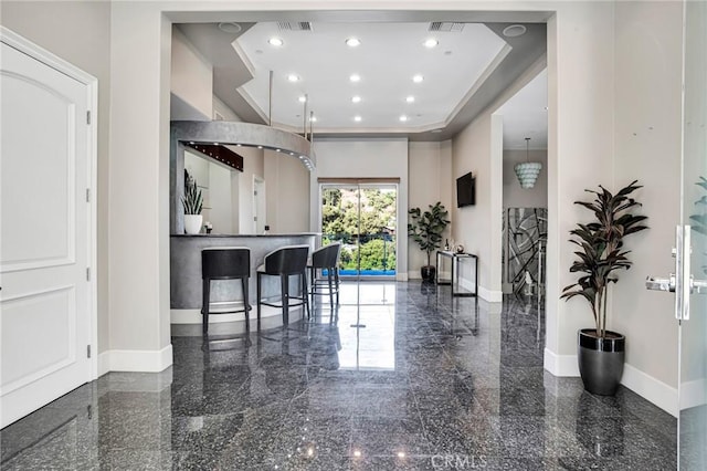 kitchen featuring a breakfast bar and a tray ceiling