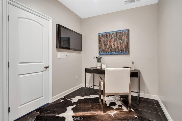 office space with dark tile patterned flooring