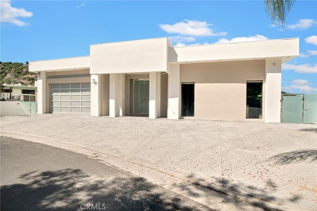 pueblo revival-style home with a garage