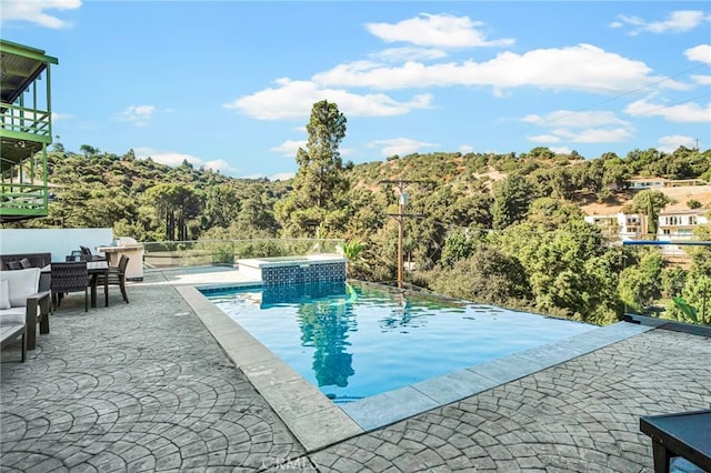 view of swimming pool featuring a patio area