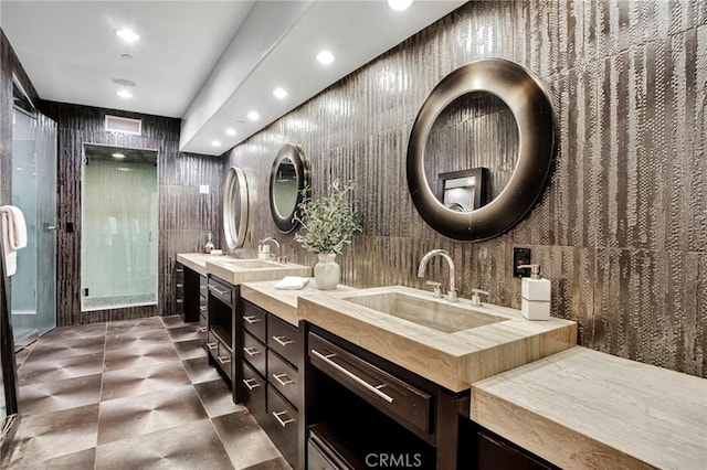 bathroom featuring vanity and tile walls