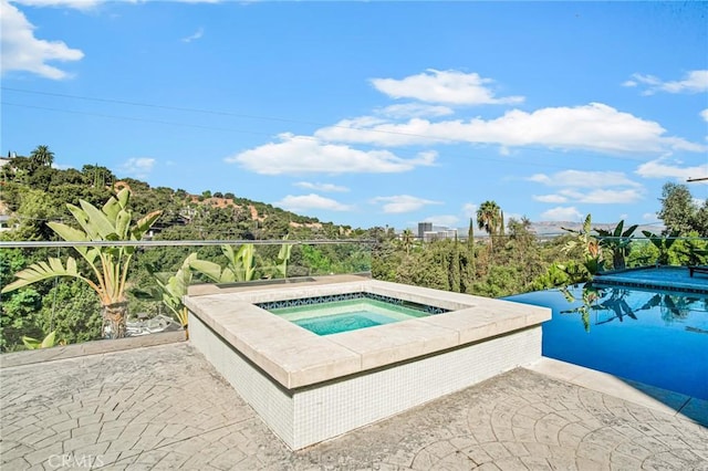 view of swimming pool featuring an in ground hot tub