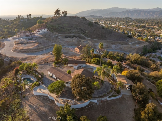 aerial view at dusk featuring a mountain view