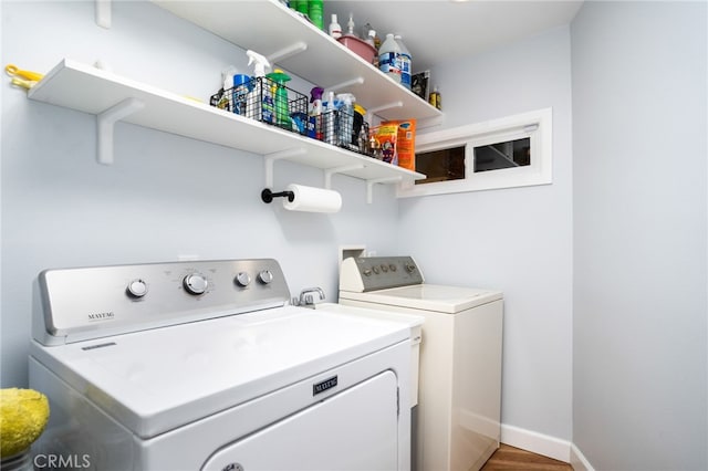 laundry area with wood-type flooring and washing machine and clothes dryer