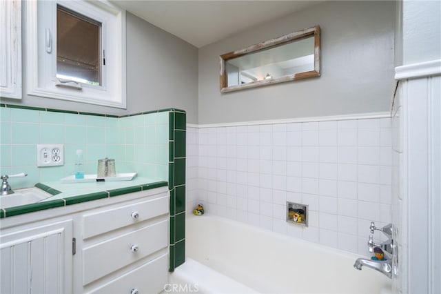 bathroom with vanity and a bath