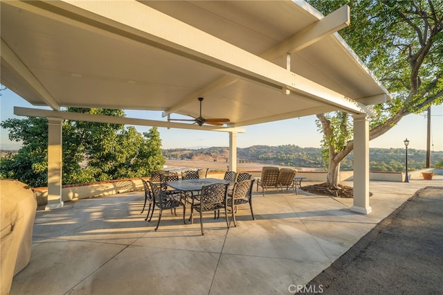 view of patio featuring ceiling fan and a mountain view